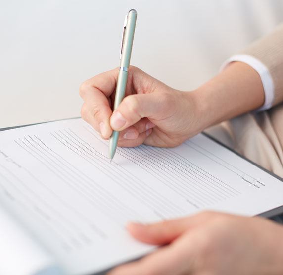 dental patient filling out form The Oral Surgery Group